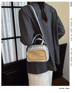 Silver ita bag showing transparent display window and sleek metallic PU leather finish