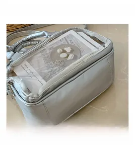 Macro shot of silver metallic bag with a clear PVC window showing internal details