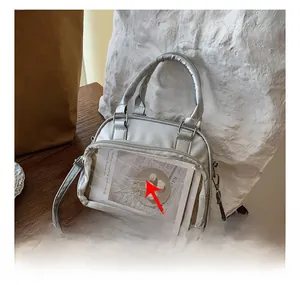 Detailed view of silver metallic bag with transparent PVC display pocket for anime pins