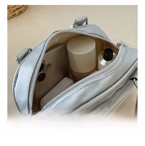 Detail showing the large interior capacity of this silver matte PU leather handbag