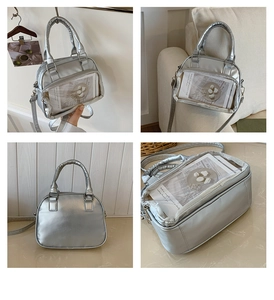 Detail of silver metallic ita bag with clear PVC window and adjustable shoulder strap
