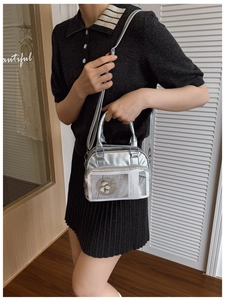 Detail showing metallic silver Boston bag with clear insert pocket and dual top handles