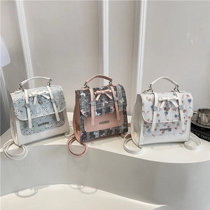 Three mini stylish floral PU leather backpacks with metal heart charms and bow details