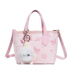 Pink printed bucket bag with cartoon graphics and plush charm on white background