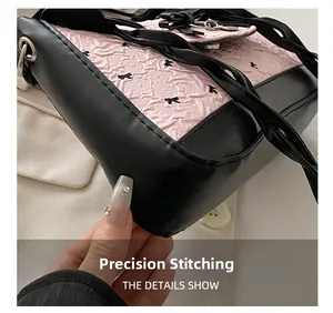 Detail show of precision stitching and bow pattern on the pink quilted shoulder bag