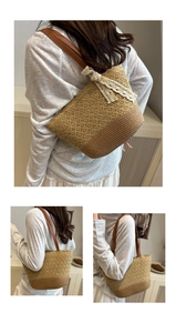 Detail of woven straw tote bag with white lace bow and brown leather shoulder straps