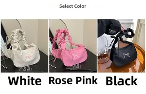Three half-moon underarm bags in white, rose pink, and black with delicate bow details