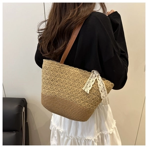 Straw woven shoulder bag featuring delicate lace bow and brown leather straps detail