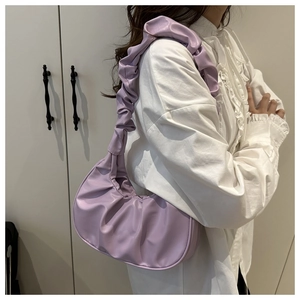 Detail of lavender ruched cloud bag with pleated handle and crescent moon silhouette