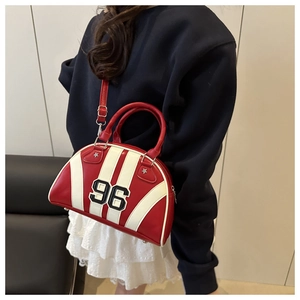 Detail of red and white shell bag with number 96 embroidery and metal bottom feet