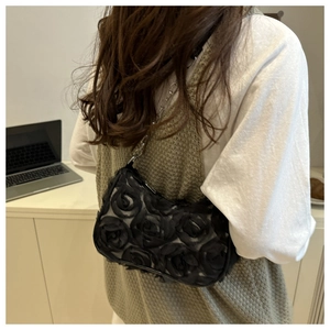 Close-up of black 3D rose tulle shoulder bag with elegant silver chain strap for women