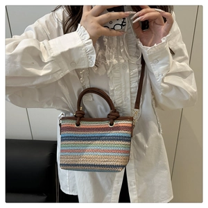 Detailed macro view of colorful striped woven texture and brown leather handle on beach bag