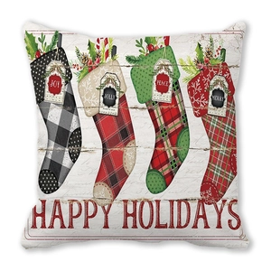 Close-up of Christmas pillow cover featuring festive socks with Happy Holidays text