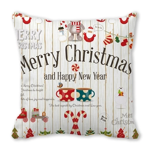 Detail of Christmas pillowcase with Santa, snowman and reindeer on wood texture