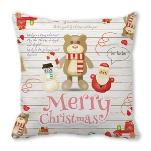 Detail of Christmas pillowcase featuring Santa, snowman and bear on white wood background