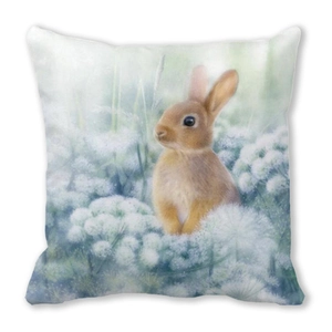 Detailed close-up of a square linen pillow featuring realistic rabbit and white flower print