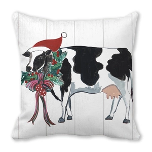 Close-up of Christmas linen pillowcase with festive cow wearing a Santa hat and wreath