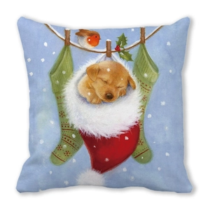 Close-up of linen pillow featuring a puppy in a red Christmas stocking print