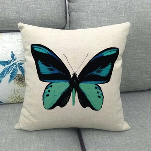 Square cushion cover with a large green and black butterfly on natural linen fabric
