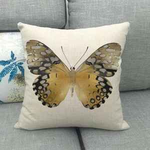 Detailed texture of cotton linen cushion with yellow butterfly print on grey sofa