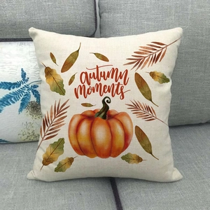 Linen pumpkin throw pillow cover with Autumn Moments text on a grey fabric sofa