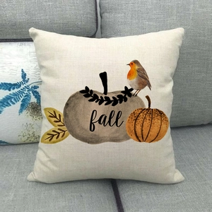 Close-up of linen pillow cover featuring hand-painted pumpkins and fall bird print