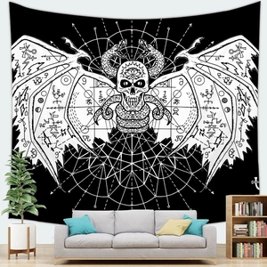 Detail of gothic skull tapestry with snake and bone wings hanging above a grey sofa