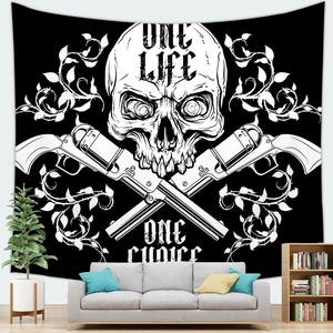 Detail of gothic tapestry featuring a skull and revolvers design hanging on a living room wall