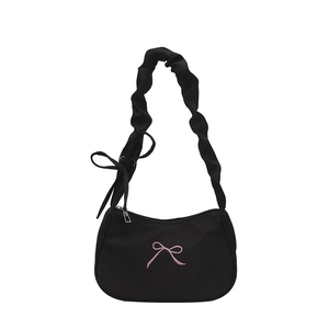 Minimalist black crescent underarm bag with pink bow embroidery and ruffled strap