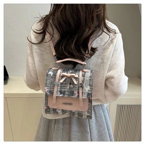 Detailed back view of a mini gray plaid backpack with pink bow and floral pattern