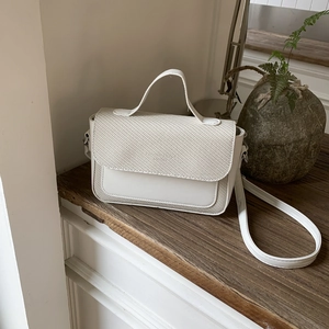 Minimalist beige woven leather small crossbody handbag with top handle and silver hardware