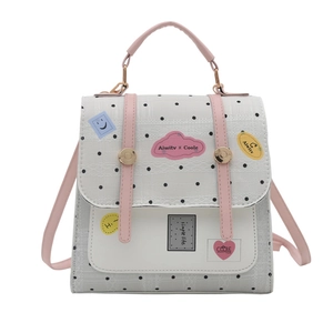 Cartoon style mini backpack in black and white polka dots with pink straps and cute patches