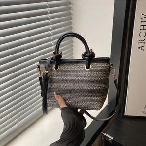 Fashionable woven bucket bag with black leather knot handle and striped fiber texture