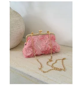 Detail of pink floral 3D mesh evening bag with vintage gold clasp and chain strap