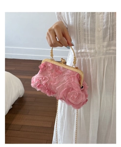 Detailed close-up of pink floral clutch with rose textures and gold metal handle