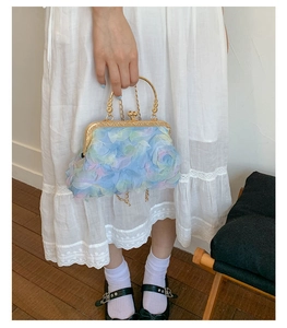 Detail of floral petal handbag with gold metal frame handle and pastel gradient textures