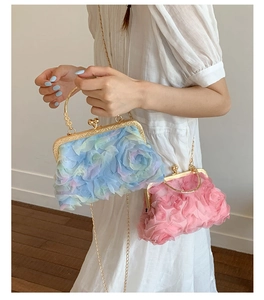 Detail of floral clutch bags with 3D petals, gold metal frames and chain straps