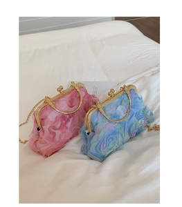 Detailed view of layered organza rose evening bags with gold chain and round handles