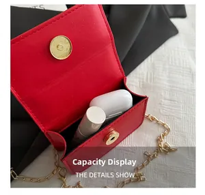 Detail view of red quilted mini bag showing interior capacity for lipstick and earbuds
