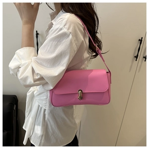 Chic pink rectangular shoulder bag with golden metallic clasp shown on female model