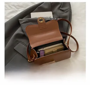 Interior view showing the storage capacity for phone, wallet, and lipstick in brown bag