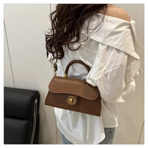 Brown retro small square bag styled with a white off-shoulder shirt for daily wear