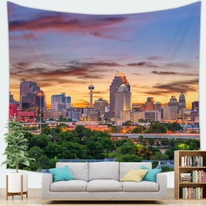 Detail of sunset city skyline tapestry hung above a modern sofa for home wall decor