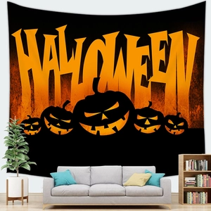 Detail of Halloween pumpkin tapestry hanging over a grey sofa in a living room decor
