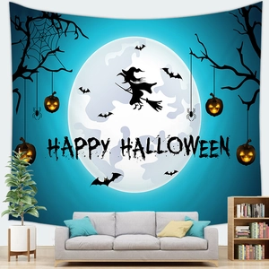 Detail of Halloween tapestry with moon and pumpkin lanterns hanging in a cozy living room