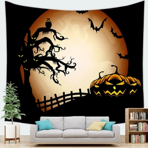Close-up of Halloween pumpkin tapestry on a living room wall above a grey fabric sofa