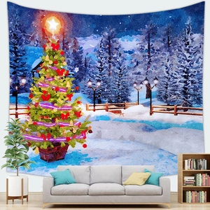 Detail of Christmas tree tapestry with snow scene hung above a modern sofa in living room