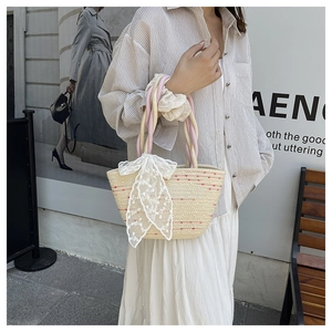 Detailed straw handbag weave with lace bow embroidery and rustic rope handles