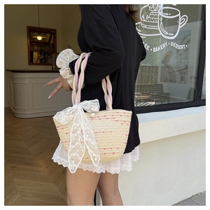 Detail of cotton rope woven beach tote with colorful dots and lace bow decoration