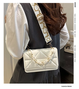White quilted crossbody bag featuring dual straps with acrylic chain and wide fabric detail